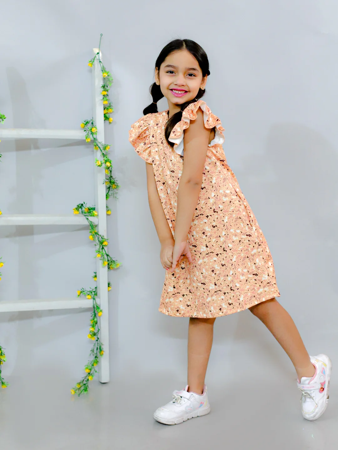 Flared sleeves all over printed A-Line knee length dress comes with concealed pockets yellow